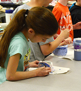 Student painting in a classroom